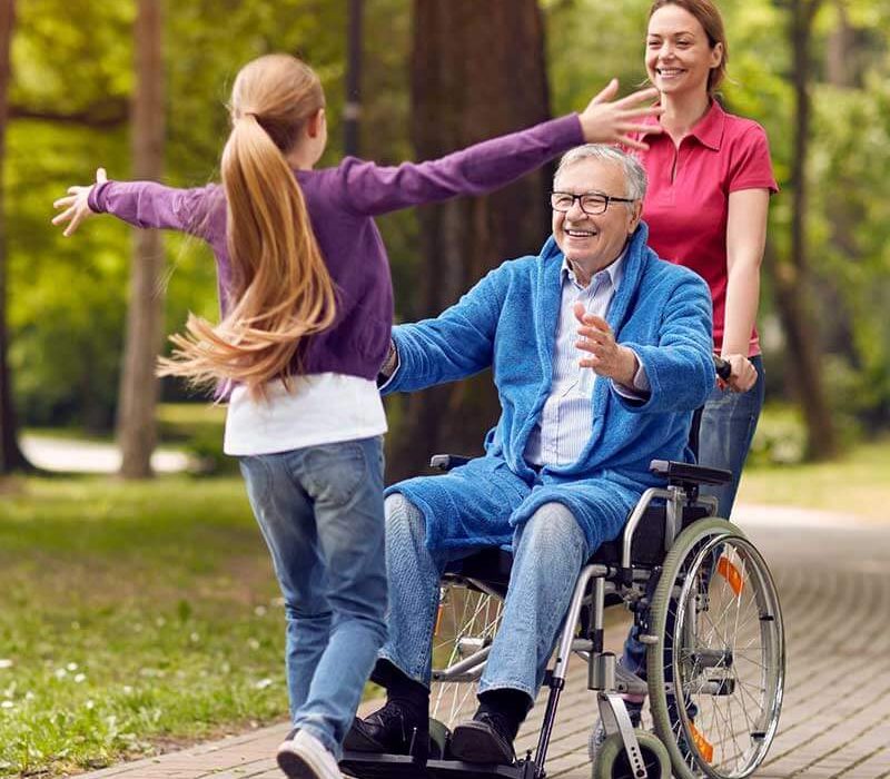 child running to grandpa in wheelchair